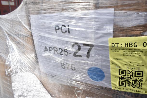 Plastic-wrapped pallet with labeled items, including trash bags, cups, and vacuum pouches. Tags show shipment details from WebstaurantStore.