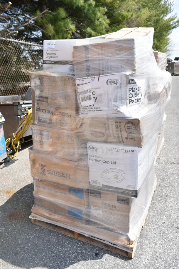 Pallet of various packaged items wrapped in plastic, including disposable gloves, plastic cutlery packs, and paper towel rolls.