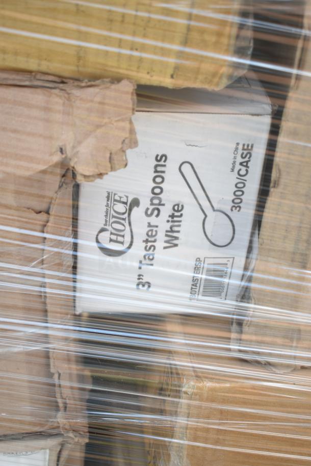 Stacked boxes of new scratch and dent items, including Choice 3" white taster spoons, wrapped in plastic.
