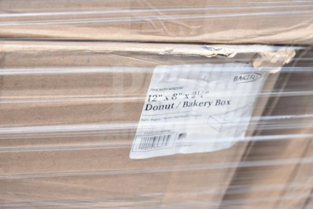 Stack of 12"x8"x2.5" donut bakery boxes with visible label, new scratch and dent condition, wrapped in plastic.