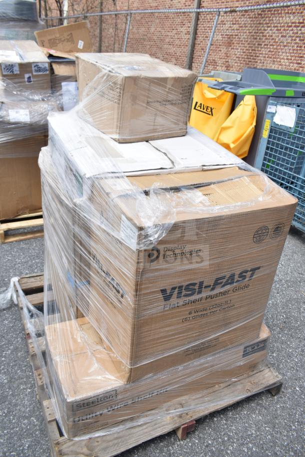 Shrink-wrapped pallet of boxes containing brand new utility shelf and Chiavari chair cushions, visible Display Technologies logo.