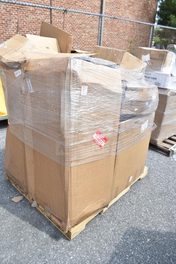 Boxed pallet of brand new scratch and dent items, including mini taco holders and fryer baskets, wrapped in plastic.