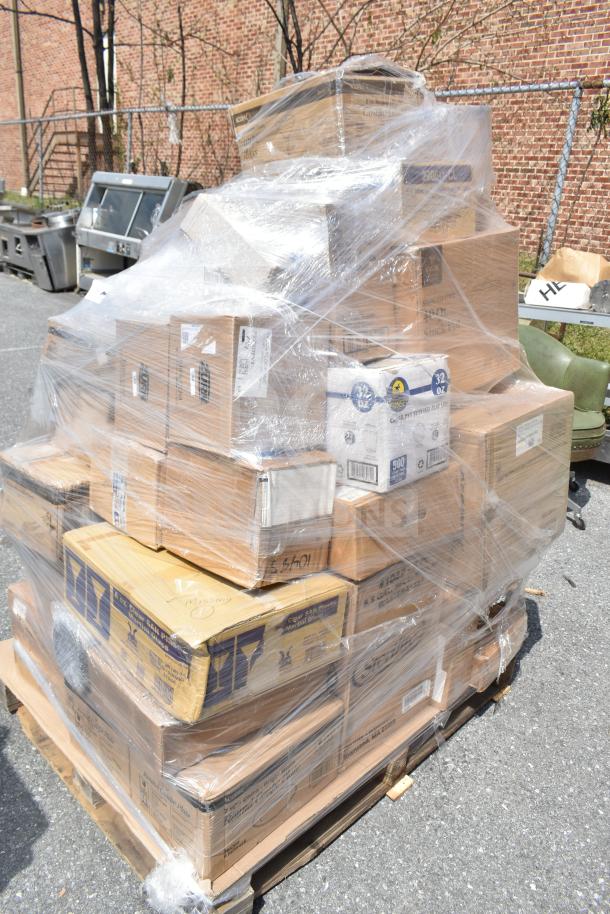 Plastic-wrapped pallet with multiple boxes of brand new scratch and dent items including plates, glasses, and containers.