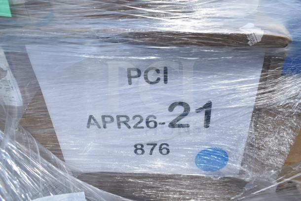 Plastic-wrapped pallet containing assorted scratch and dent items, including plates, a wastebasket, and a speed rail. Marked "PCI APR26-21 876".
