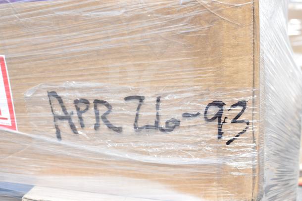 Pallet of 38 new scratch and dent items, including glasses, hood filters, and cake pans, marked "APR26-93," wrapped in plastic.