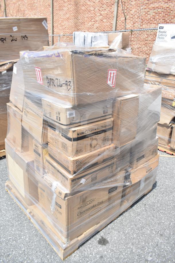 Shrink-wrapped pallet of boxed items labeled "Acopa" and "Baker's Lane" including glasses and cake pans, marked "APR26-93."