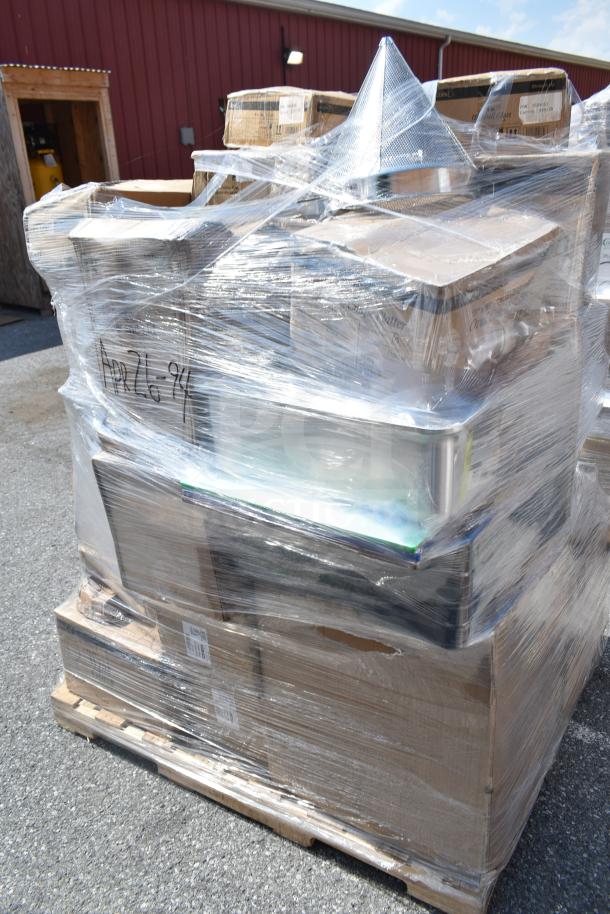 Stack of assorted brand new scratch and dent items, including plates, rocks glasses, and ingredient bin, wrapped on a pallet. Marked "APR26-94."