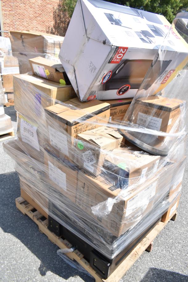 A pallet of 29 brand new scratch and dent items, including a fry basket, julienne disc, and convection oven stacking kit, wrapped in plastic.