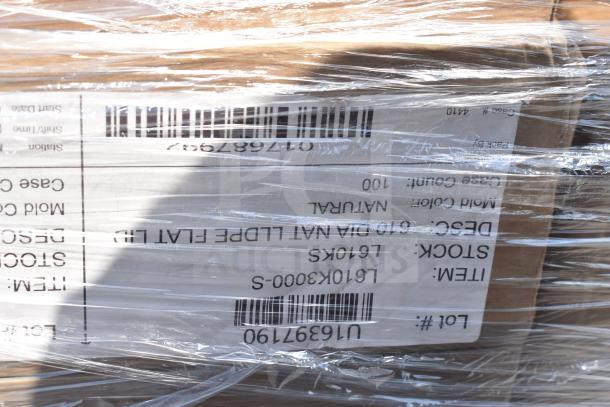 Packaged auction items wrapped in plastic, displaying a label with stock and case information. Items include fry basket, julienne disc, and more, in scratch and dent condition.