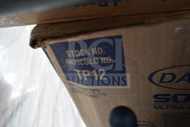 Cardboard box with visible label "Stock No. Artículo No. TP12," part of auction lot with new scratch and dent items.