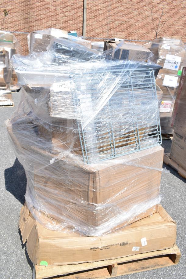 Plastic-wrapped pallet with mixed items including a Regency 16-gauge work table in original boxes, visible scratch and dent conditions.
