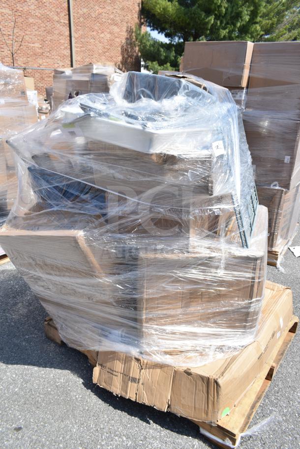 Plastic-wrapped pallet containing 17 new scratch and dent items, including a work table and glasses, on a warehouse floor.