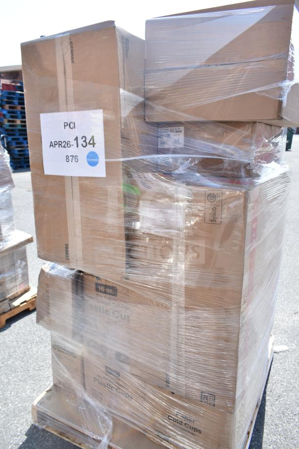 Plastic-wrapped pallet with multiple boxes labeled "Plastic Cup" and "Paper Cold Cups," marked PCI APR26-134, containing new scratch and dent items.