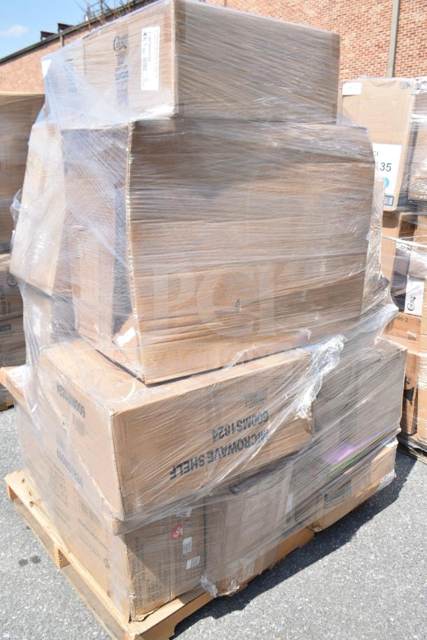 Pallet of brand new scratch and dent items wrapped in plastic, including boxes labeled for mixing glasses, plates, and towel dispensers.