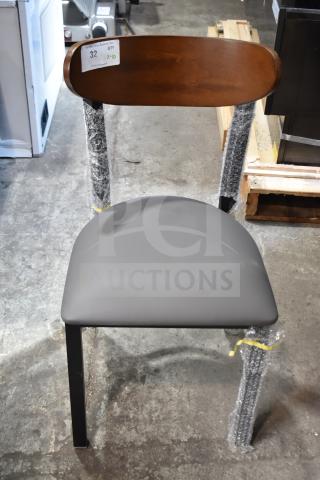 Brand new Lancaster dining chair, wooden back, gray cushion, metal frame. Scratch and dent condition. Auction tag visible.