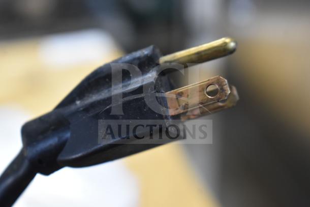 A close-up of a plug from the 2024 FWE TS-1633-36P heated holding cabinet, 115 volts, 1 phase, on commercial casters.