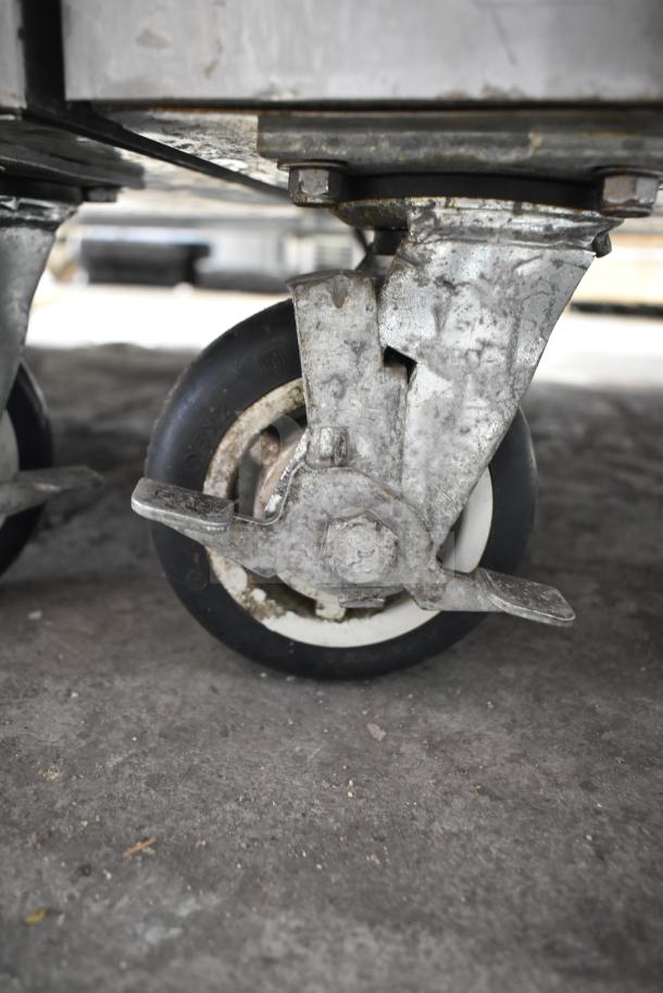 2017 FWE TS-1633-36P commercial holding cabinet caster, showcasing durable wheel and locking mechanism.