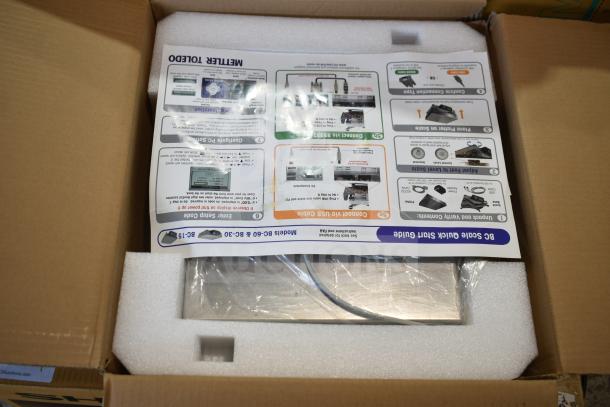 Mettler Toledo BC Commercial Countertop Food Portioning Scale in packaging, includes a quick start guide, new condition.