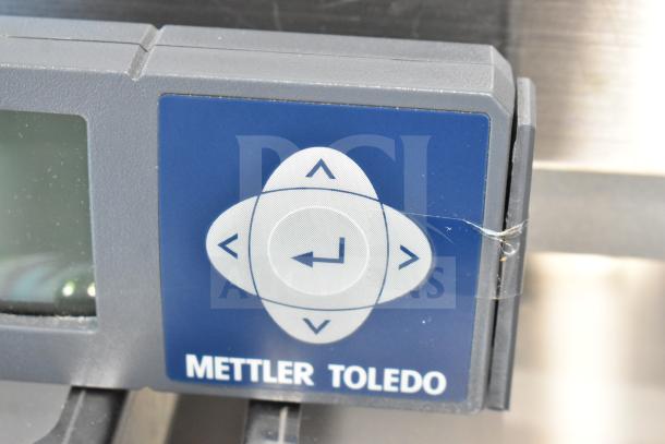 Mettler Toledo BC Commercial countertop food portioning scale, featuring control panel with arrow buttons, in good condition.