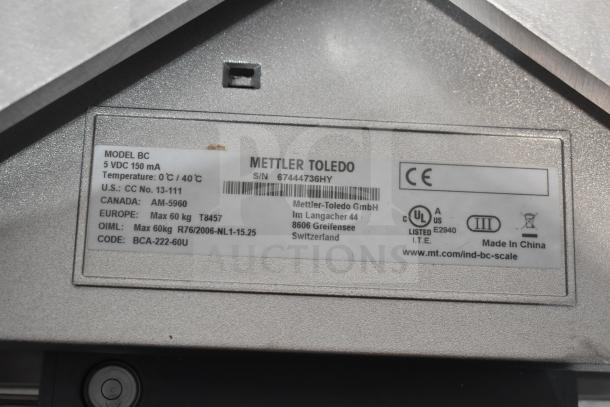 Mettler Toledo BC commercial countertop food portioning scale label, showing model, voltage, temperature range, and approvals.