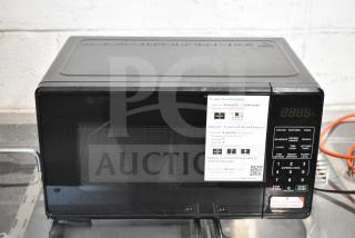 Brand new, scratch and dent Hamilton Beach MS8436127995-01 countertop microwave oven, 120V, 1-phase; instructional label visible.