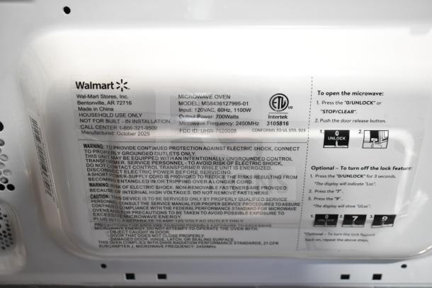2025 Hamilton Beach MS8436127995-01 microwave oven label detail, 120V, 60Hz, 1100W input, 700W output. Made in China.