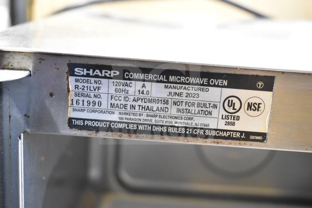 2023 Sharp R-21LVF Commercial Microwave Oven label showing 120V, 1 Phase, model details, and manufacturing info.