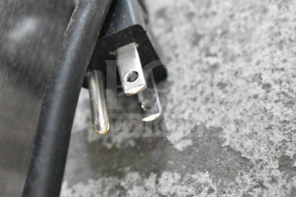 Close-up of a three-prong electrical plug for the Bunn VPR 33200.0015 Pourover Coffee Brewer, 120 volts.