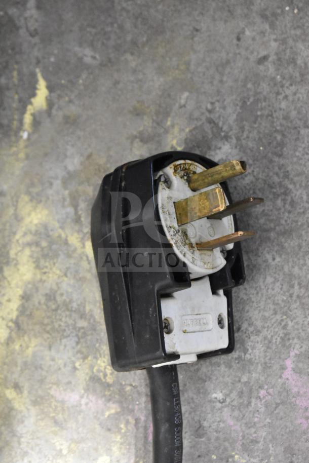 Close-up of a Hubbell 208-volt, 3-phase plug, likely from a Fri-jado TDR7-P commercial rotisserie oven.