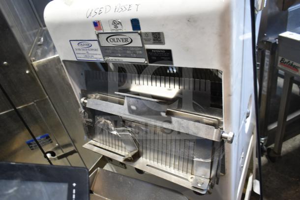 Oliver 797-32NC Commercial Bread Slicer with Pro Guard Safety Chute, 115V, 1 Phase. Used condition, visible asset tags.