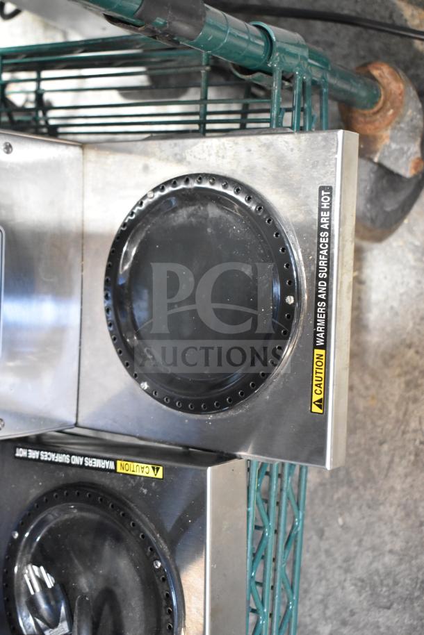 Bunn VP17-2 13300.0002 Pourover Coffee Brewer with 2 Warmers, stainless steel, "Caution: Surfaces Are Hot" label visible.