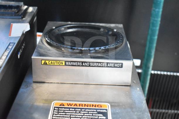 Bunn VP17-2 coffee brewer with 2 warmers, 120 Volts, warning labels for hot surfaces, in used condition.