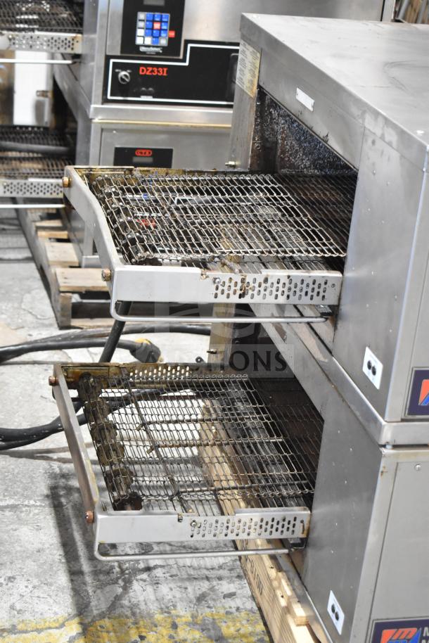 Two Middleby Marshall CTX DZ33T stainless steel conveyor pizza ovens, tested, working, on casters. 208V, 3/1 phase.