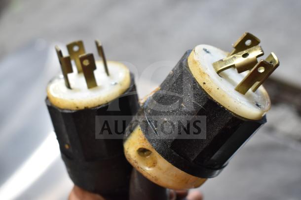 Close-up of two electrical plugs for Middleby Marshall CTX DZ33T conveyor pizza ovens, showing prongs and casing detail.