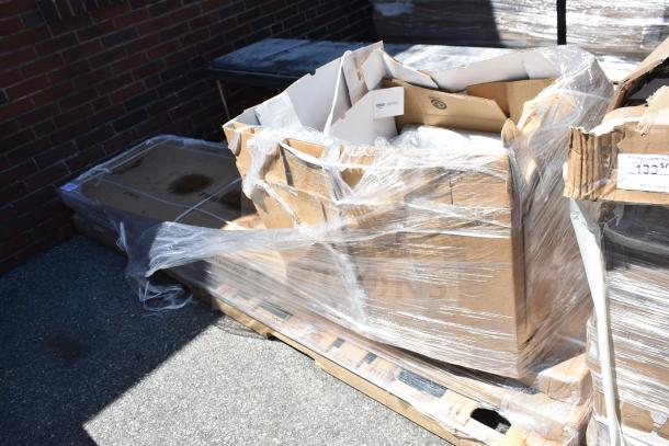 Packaged items on pallet including a work table and mop sink, partially wrapped in plastic, labeled for auction APR26-60.
