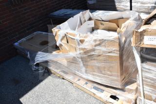 Packaged items on pallet including a work table and mop sink, partially wrapped in plastic, labeled for auction APR26-60.