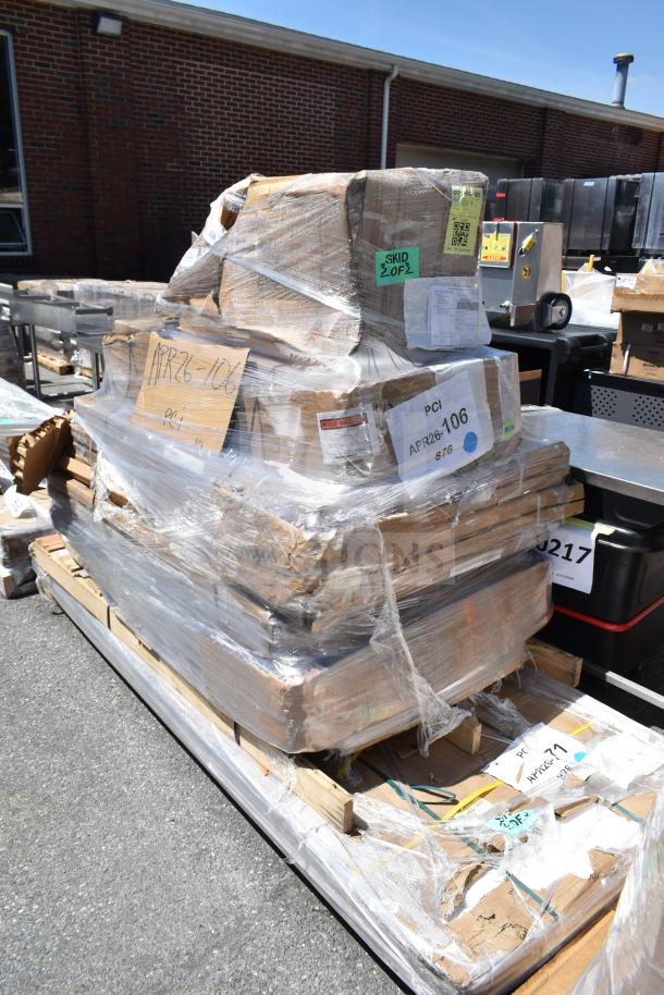 Wrapped pallet of 7 new scratch and dent items including sheet pan rack, labeled APR26-106, showing signs of packaging wear.