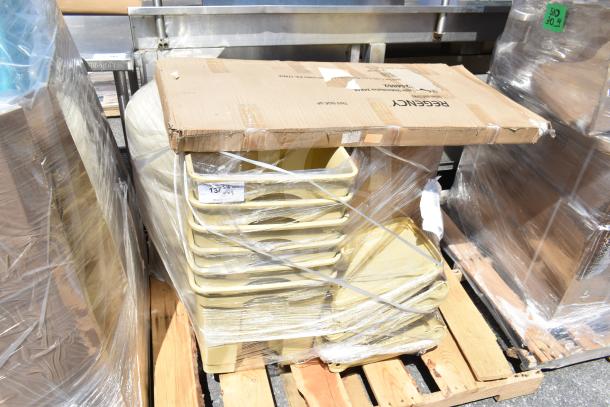 7 brand new scratch and dent items on pallets, including beige bins and cardboard boxes, sealed with wrap.