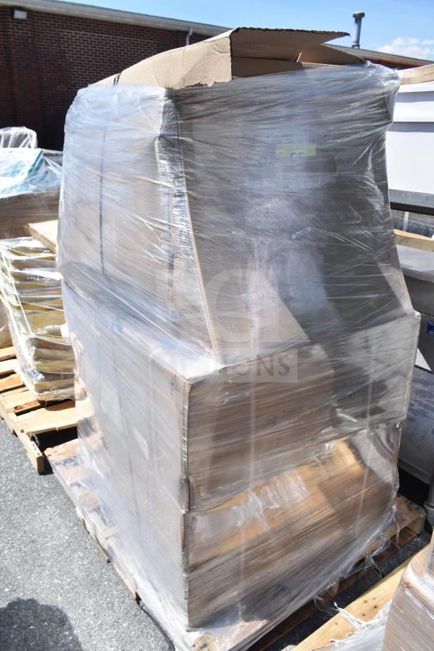 Pallet of brand new scratch and dent items wrapped in plastic, showing cardboard boxes, APR26-118 label visible.