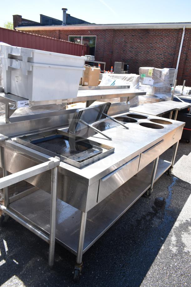 Commercial prep table with four round cutouts, two drawers for sauce pots, on commercial casters. Stainless steel finish.