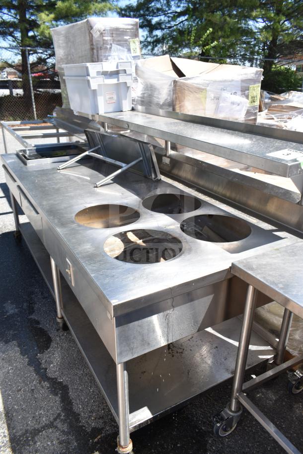 Commercial prep table with four round cutouts, two drawers with sauce pot cutouts, on commercial casters in good condition.