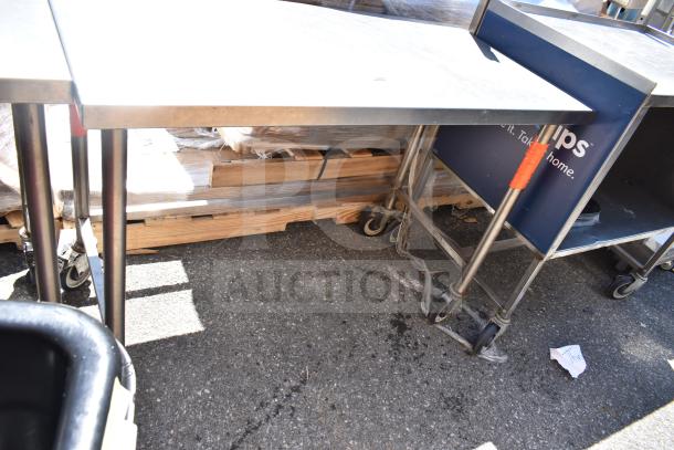 Commercial metal table with robust build on heavy-duty commercial casters. Used condition, suitable for industrial use.