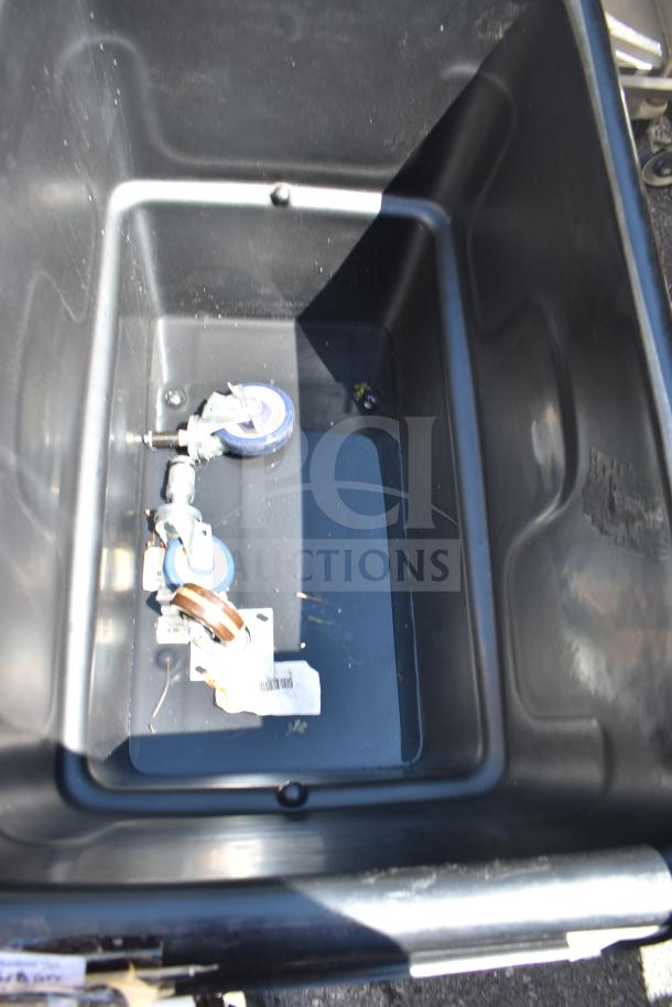 Rubbermaid FG470800BLA black utility cube truck, 8 cu. ft., scratch and dent, 700 lb capacity, visible wheels inside.