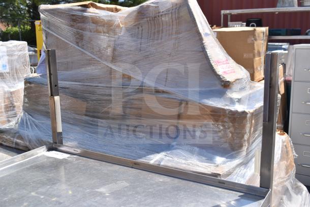 Commercial portable counter with under shelf, metal frame, on commercial casters, wrapped and in used condition.