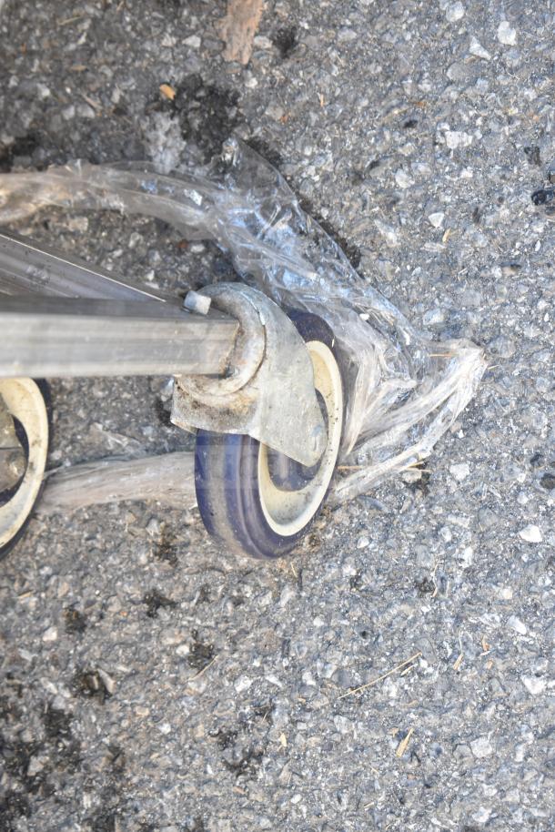 Commercial portable counter caster on pavement, showing wear. Equipped with durable commercial wheels wrapped in plastic.