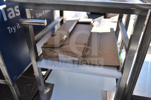 Face to Face commercial meat slicer equipment stand with stainless steel frame, dual shelves, and visible cardboard packaging.