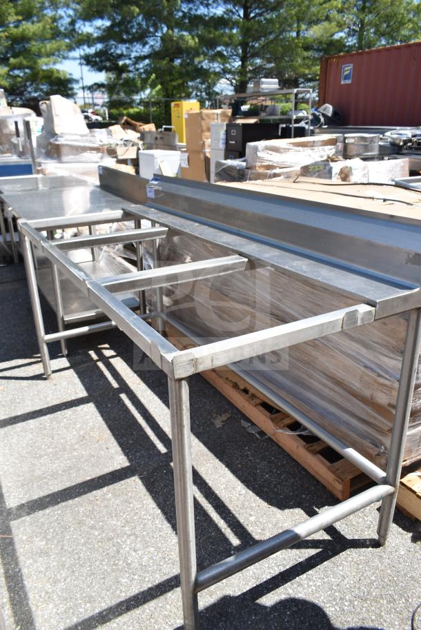 Universal commercial cutting table frame, stainless steel, rectangular structure, outdoor setting, good condition.