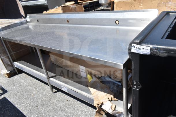 Winholt commercial table with backsplash, stainless steel, under shelf, slightly used, visible labels and markings.