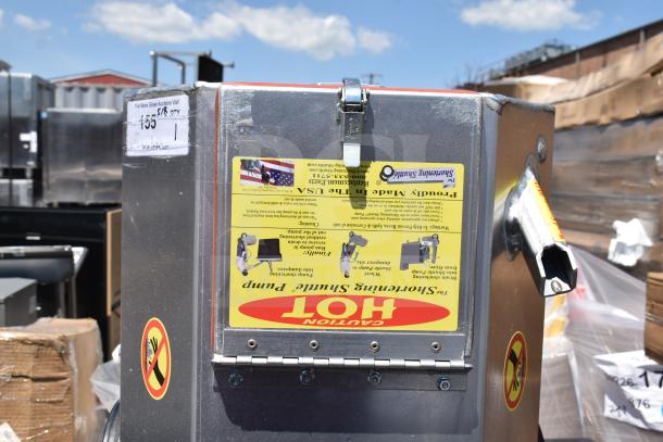 Brand new Shortening Shuttle Pump; visible scratches and dents. Safety and operation labels with usage instructions included.