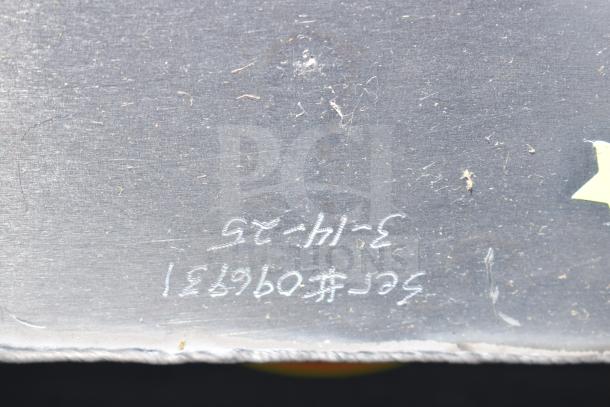 Alt text: Close-up of surface on shortening shuttle pump with scratches and handwritten markings, indicating new condition with cosmetic flaws.